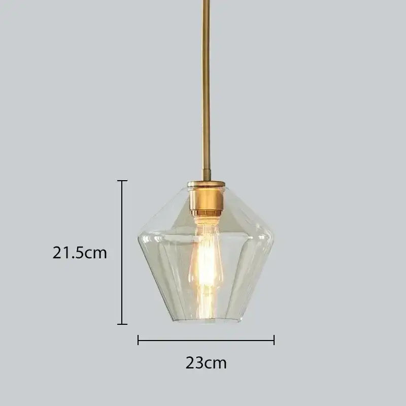 A modern pendant light with clear faceted amber glass and brass finish ideal for dining room or living room chandelier