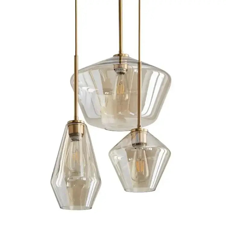 Set of three modern amber glass chandelier pendant lights with faceted shades and brass fixtures for living room or dining room