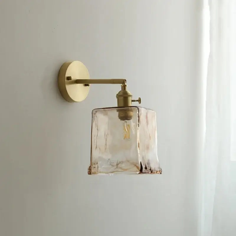 Modern amber glass copper led wall lamp with brass finish and textured translucent shade for bedroom sconce lighting
