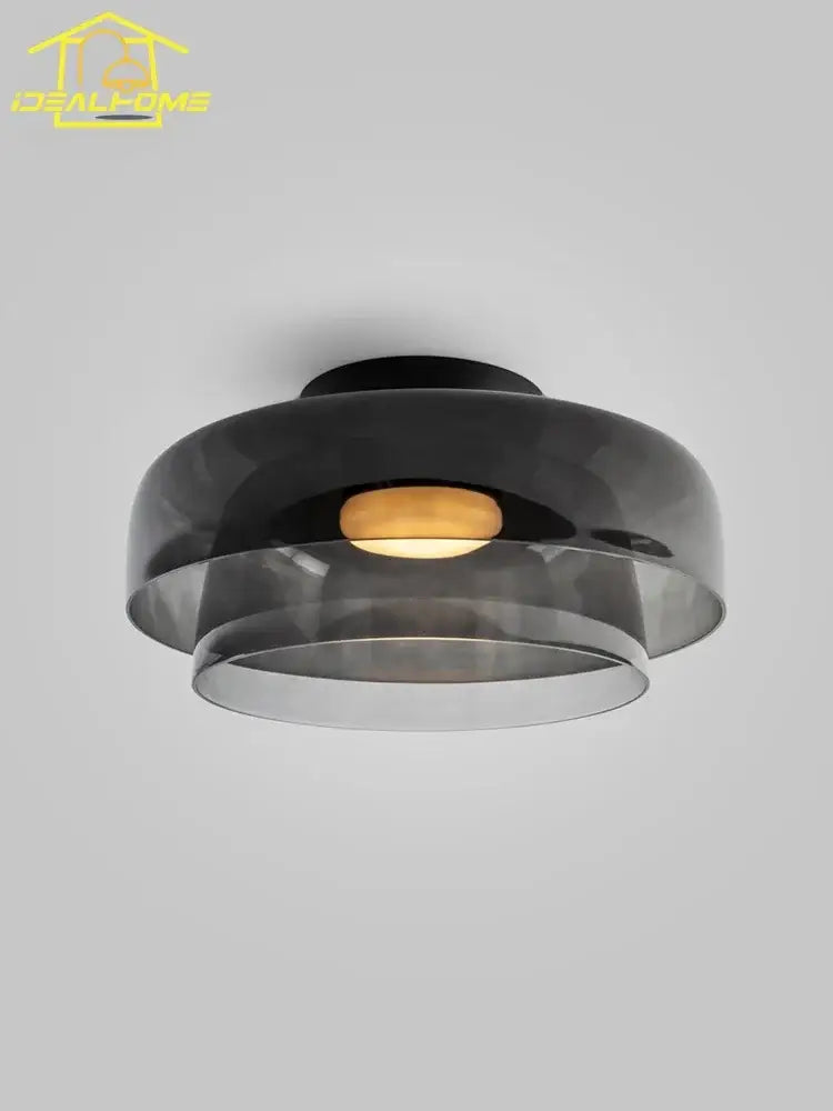 Modern amber glass led ceiling light with black glass concentric rings and warm glowing bulb for living room ceiling light
