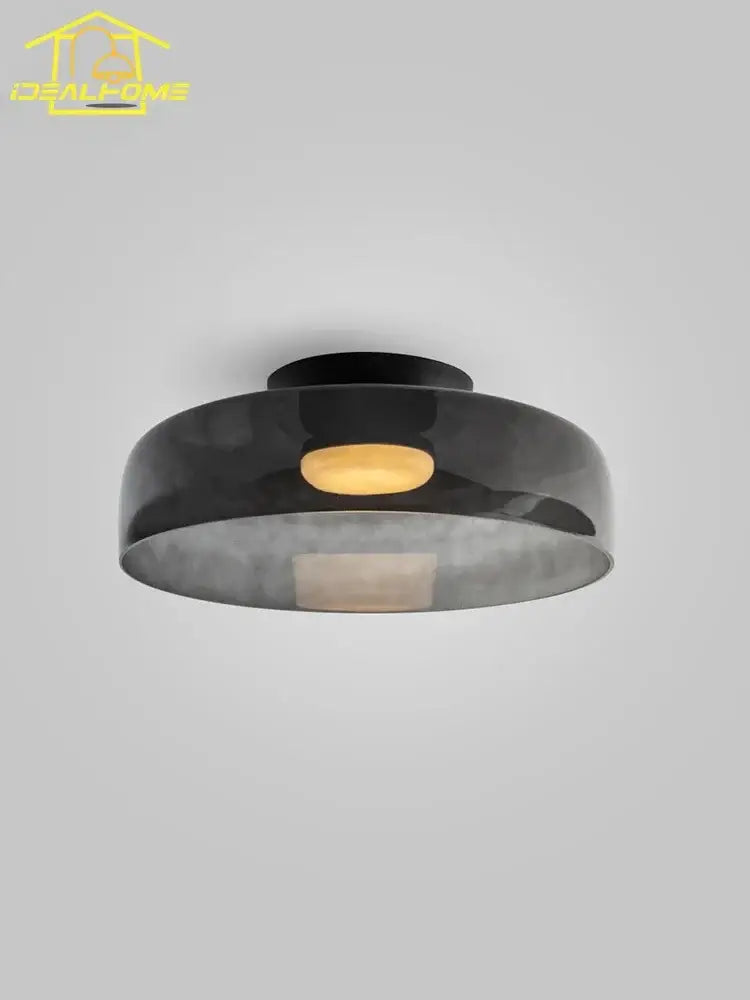 Black matte modern amber glass led ceiling light with circular glass shade and illuminated amber center for living room