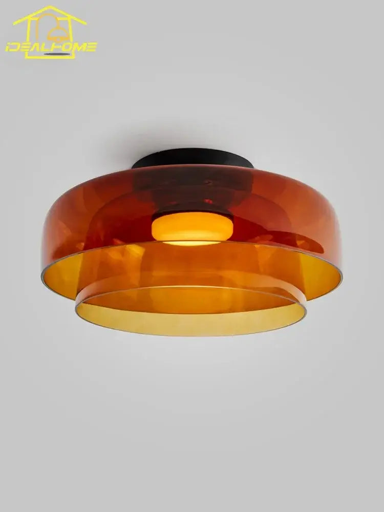 A modern amber glass led ceiling light with layered translucent shade and black base for living room ceiling light