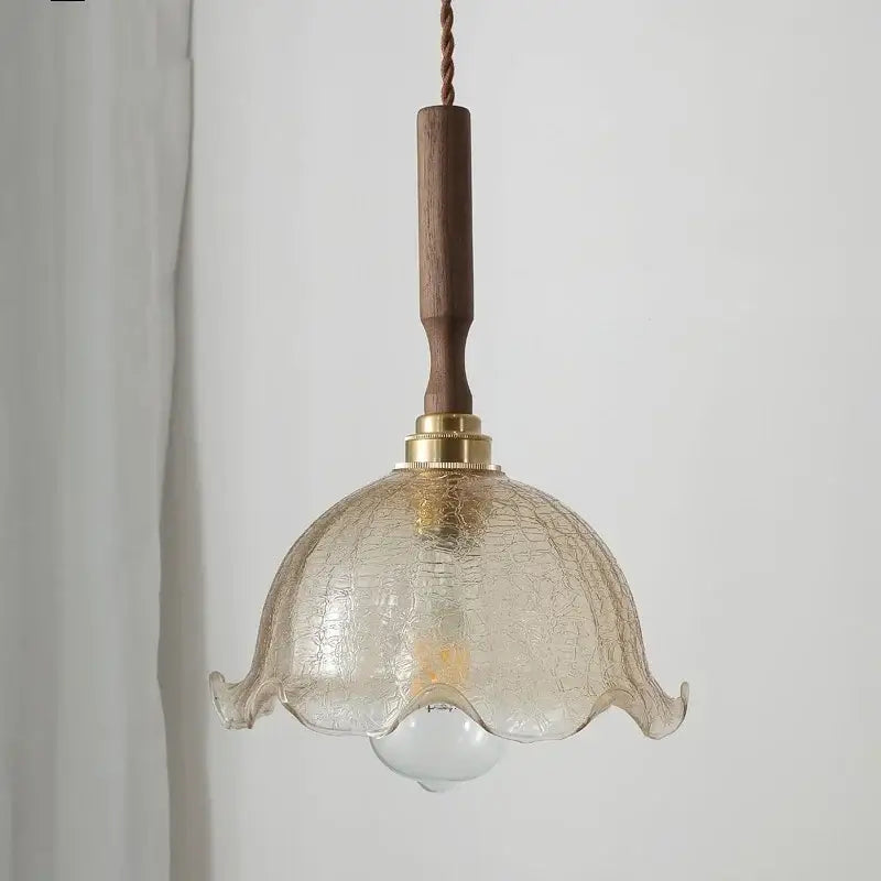 Modern amber glass led pendant lamp with crackled translucent glass and warm brass accents on walnut wood handle