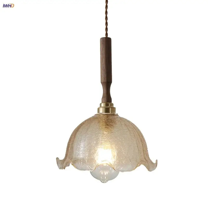 Modern amber glass led pendant lamp with warm-toned crackled glass, wooden stem, and brass accents for dining room lighting
