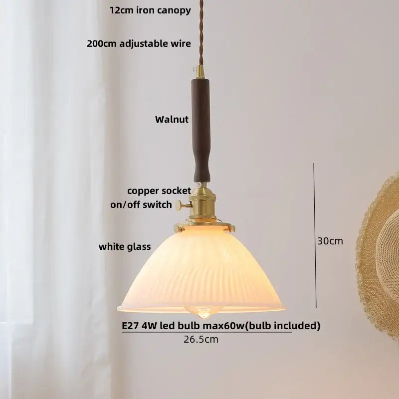 A warm-toned ribbed white glass led pendant lamp with walnut iron canopy and copper socket for modern dining rooms