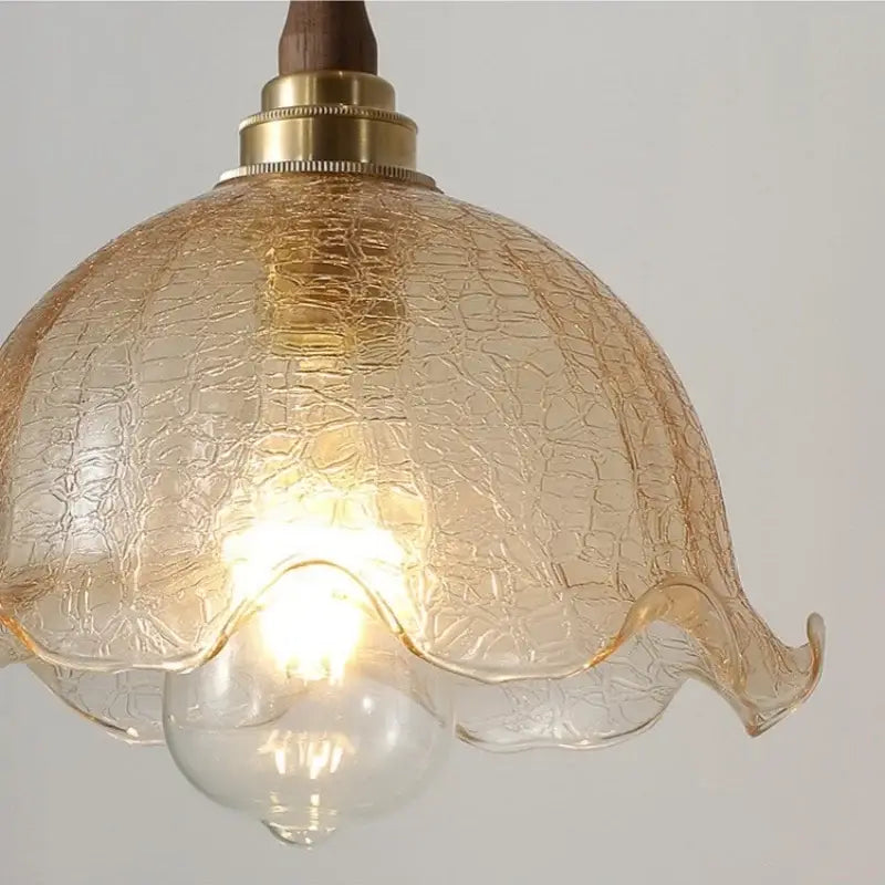 Modern amber glass led pendant lamp with warm crackled glass, brass fixture, and walnut wood accent for dining room