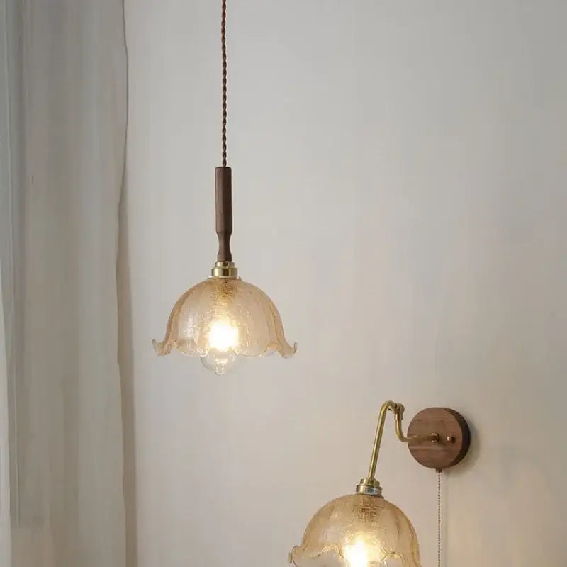 Modern amber glass led pendant lamp with warm-toned hand-blown fluted design and walnut wood accent cord