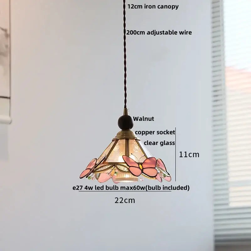 Modern amber glass led pendant light with pink stained glass butterflies, walnut canopy, and copper accents for dining room