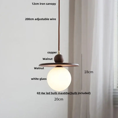 Modern amber glass led pendant light with warm copper iron canopy walnut wood accents and white glass globe for dining room
