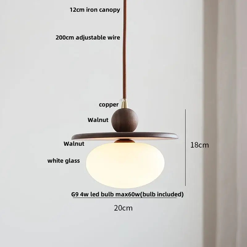 Modern amber glass led pendant light with warm white glass globe and dark walnut wood accents for dining room lighting