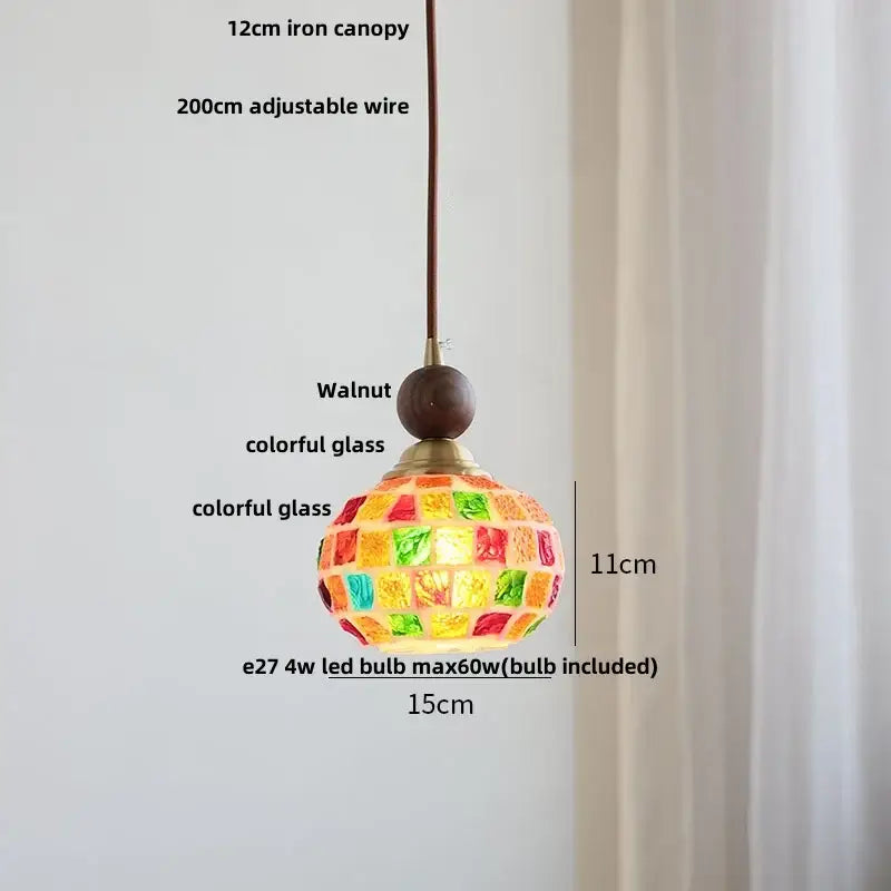 Modern amber glass led pendant light with vibrant mosaic stained glass, walnut top, and brass accents for dining room