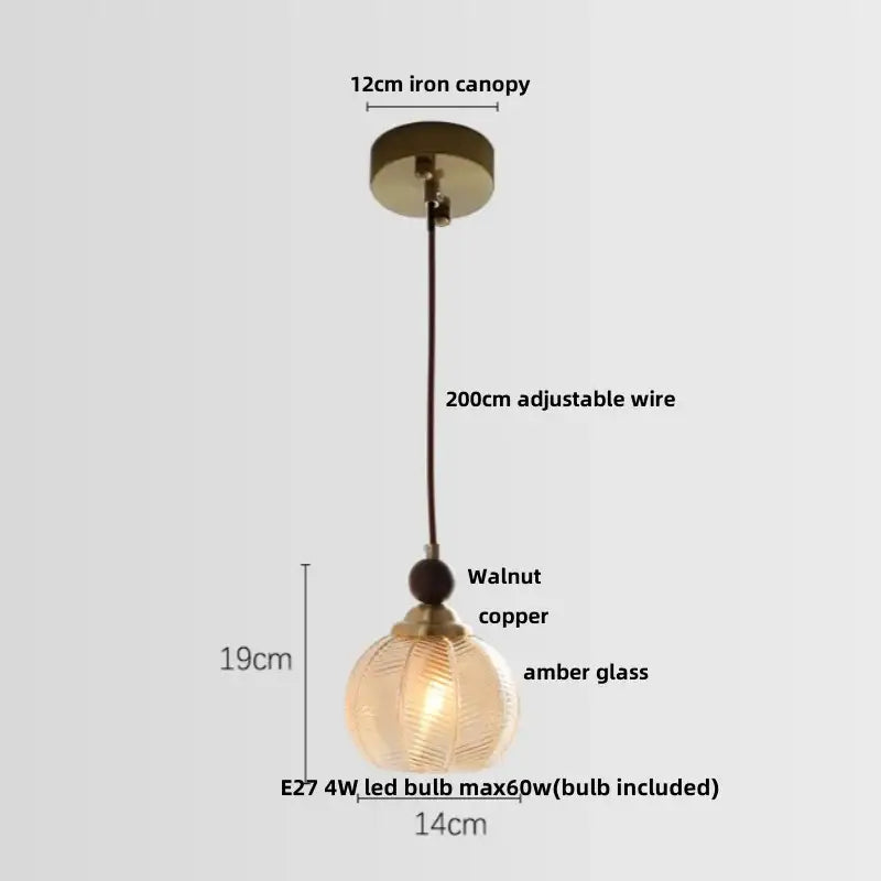 Modern amber glass led pendant light with textured spherical shade and copper accents for dining room use