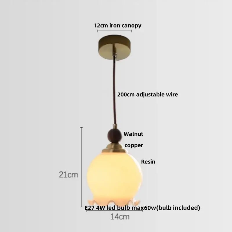 Modern amber glass led pendant light featuring a warm translucent resin shade with walnut copper accent and iron canopy