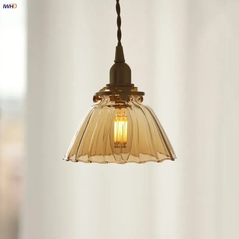 Modern amber glass led pendant light with fluted scalloped design and dark bronze fixture for kitchen lighting