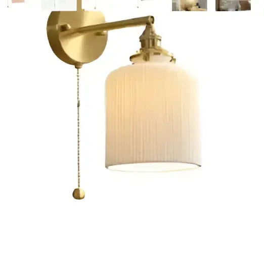 Modern amber glass led wall lamp featuring a gold-toned brass sconce with ribbed off-white glass shade for bedroom use