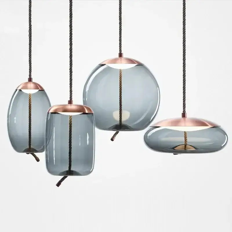 Modern amber glass pendant light with frosted gray shades and rose gold tops by decorbites brokis knot glass design