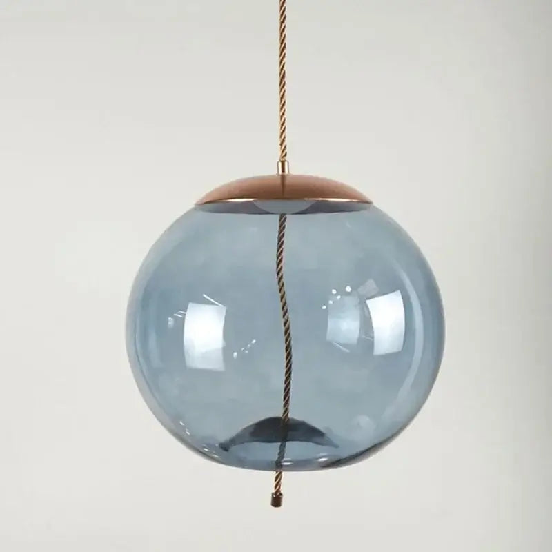 A sleek translucent blue brokis knot glass pendant light with copper cap ideal for modern bedroom decorbites brokis knot