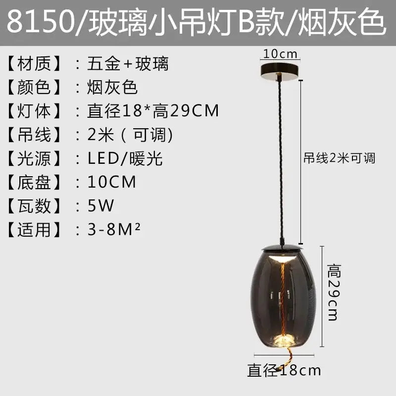 Modern amber glass pendant light with smoky gray brokis knot glass and gold accents featuring warm led glow decorbites brokis knot