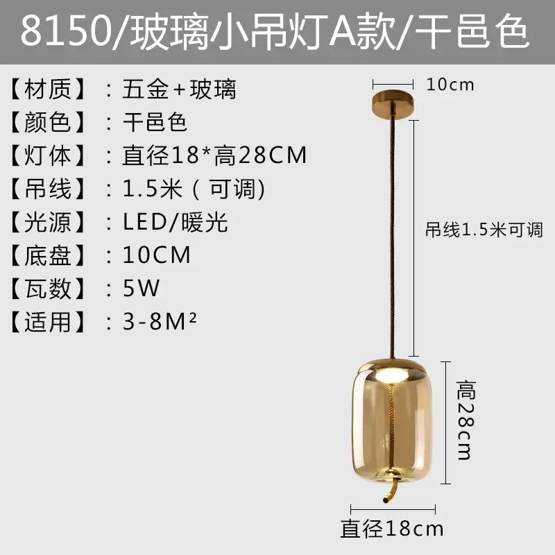 Modern amber glass pendant light with gold accents featuring sleek cylindrical brokis knot glass and warm led illumination
