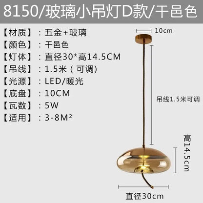 A sleek gold-toned amber glass pendant light with modern rounded design and adjustable 1.5-meter cable by brokis knot