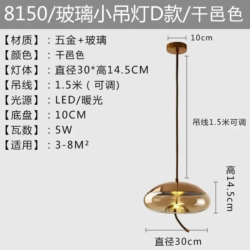 A sleek gold-toned amber glass pendant light with modern rounded design and adjustable 1.5-meter cable by brokis knot