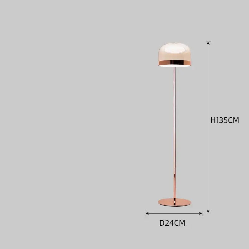 A sleek rose gold floor lamp with a translucent dome shade paired with a modern amber glass pendant light copper finish