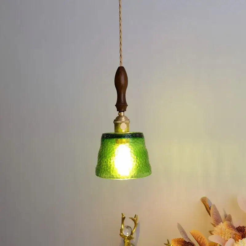 Modern amber glass pendant light with green textured glass, dark wood handle, and hammered brass decorbites amber pendant design
