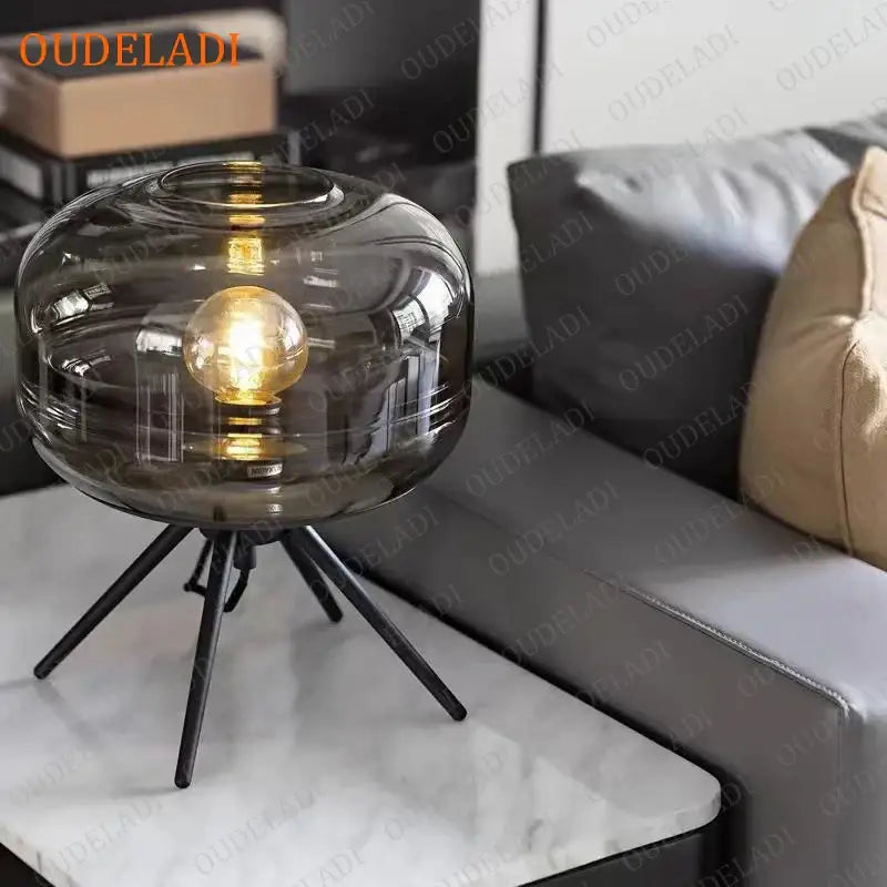 Modern amber glass table lamp with a smoked glass amber shade and black tripod base ideal for bedroom decorbites decor