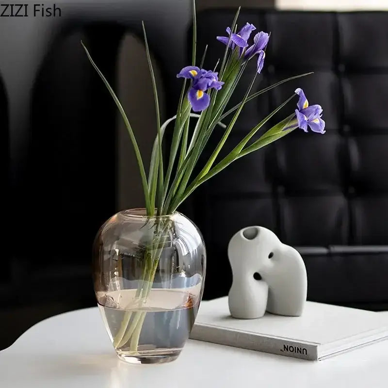 Clear glass vase with purple irises showcased alongside decorbites amber glass transparent flower pot for living room decor