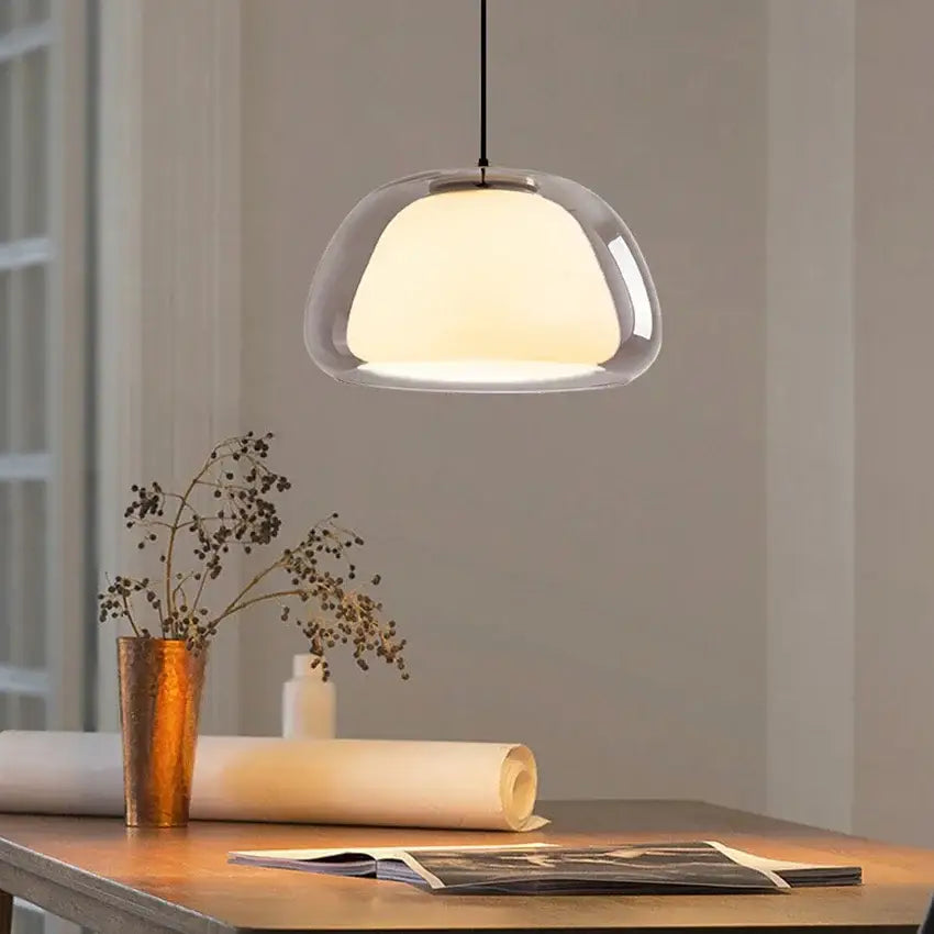 Modern amber and gray double glass pendant light with clear glass dome and warm glow for dining room use