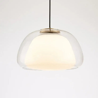 Modern amber and gray double glass pendant light with brass accents and warm glow for dining room lighting