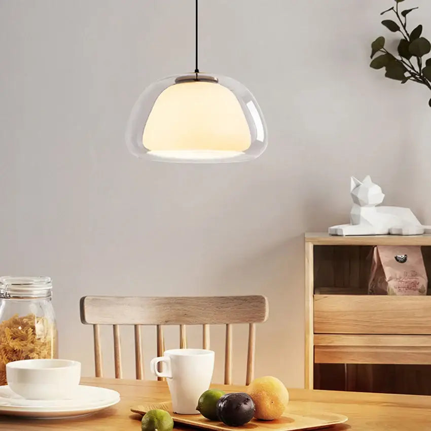 Modern amber and gray glass pendant light with warm diffused glow and sleek metallic fixture for dining room