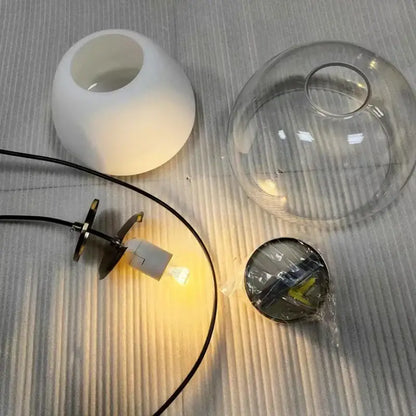 Modern amber and gray double glass pendant light featuring a white matte ceramic lampshade and clear glass pendant