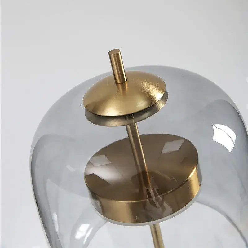Modern amber and gray glass table lamp with a glass dome pendant light and brushed brass base for decorbites glass table