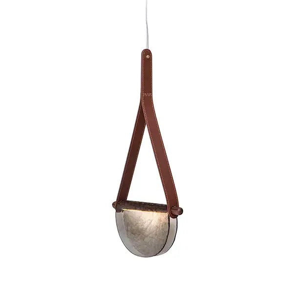 Brown leather strap suspends a half-moon brushed metallic pendant lamp in decorbites handmade leather glass design