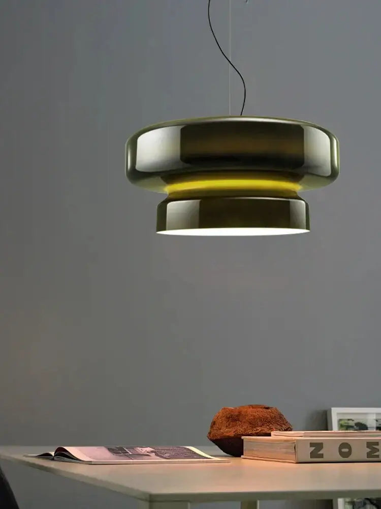 Modern brushed chrome pendant light with sleek tiered design and warm yellow illumination for decorbites amber green decor