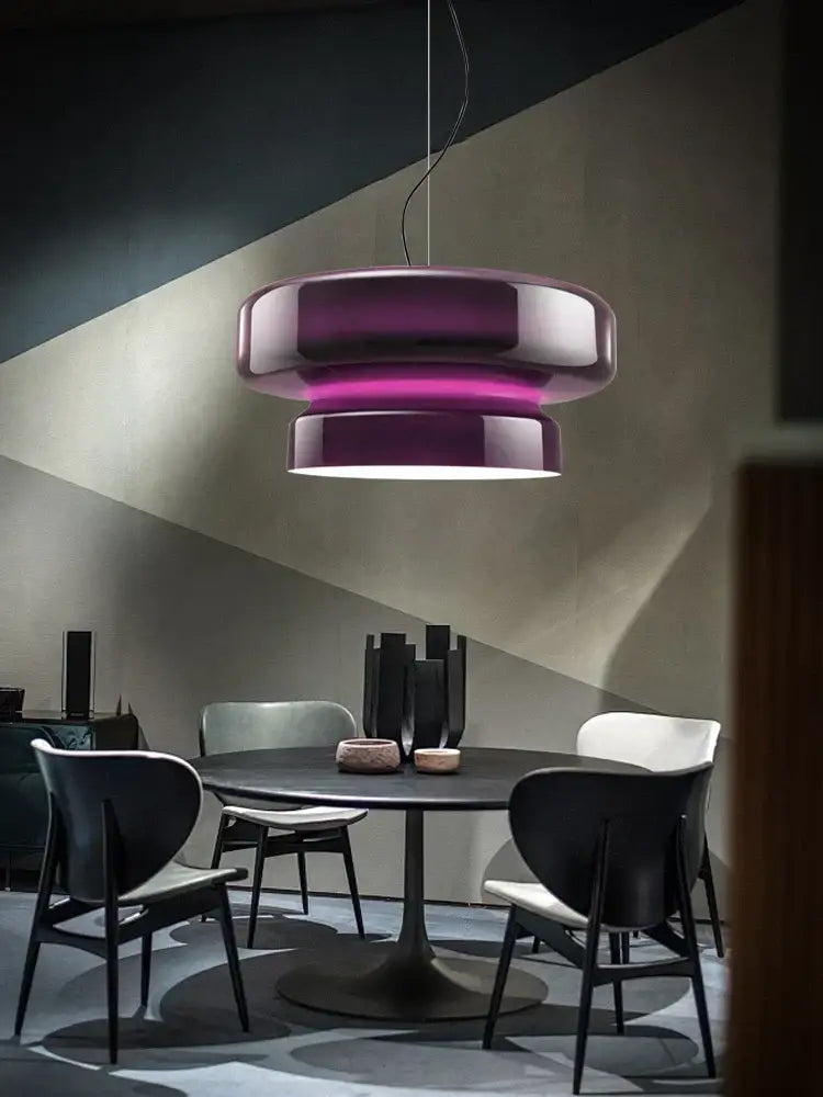 A sleek modern pendant light with glossy purple white gradient complements decorbites amber green glass dining room decor