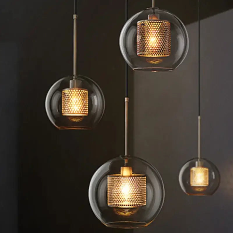 Modern amber decorbites glass ball pendant light with warm-toned brass mesh shade ideal for kitchen lighting