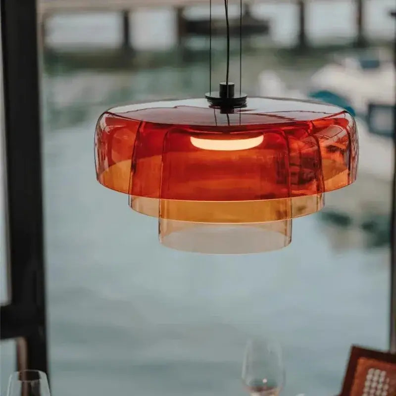 Modern amber layered glass pendant light with translucent orange shade featuring decorbites levels colorful glass design