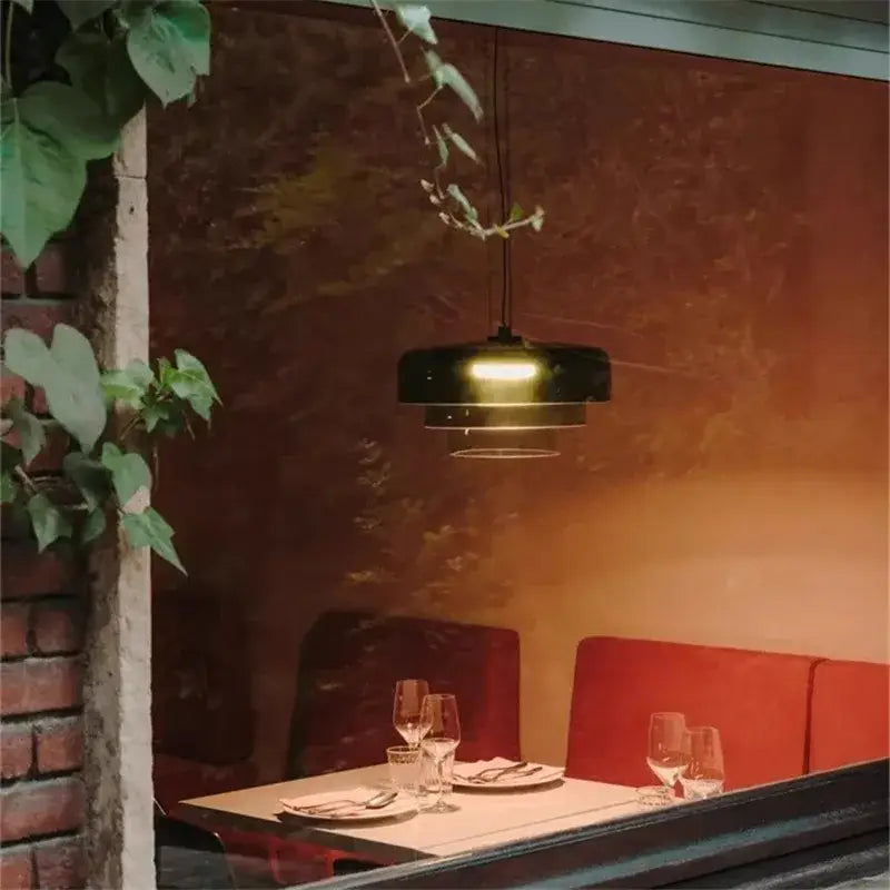 Modern amber layered glass pendant light with sleek black design and warm glow perfect for dining room decorbites levels colorful