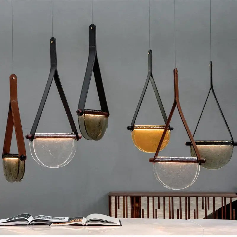 Modern amber and matte gray handmade glass pendant lamp with black metal frame and leather straps for bedroom decorbites handmade glass