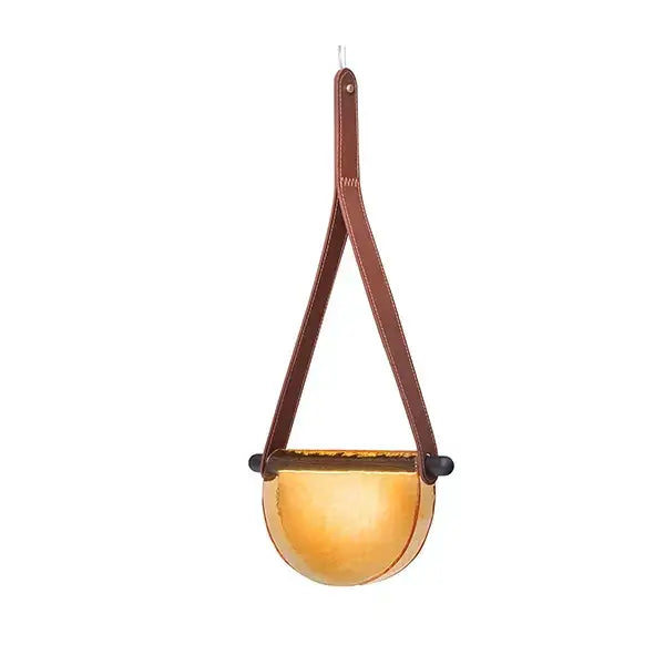 Brown leather strap suspends a golden hammered metal hanging planter with modern amber decorbites handmade glass pendant lamp