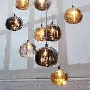 Modern amber and smoke crystal staircase chandelier with spherical glass pendant lights for living room lighting