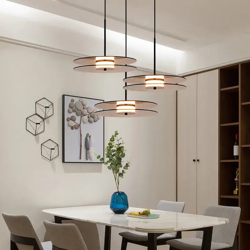 Modern amber smoke gray glass pendant lamp with sleek black cords and warm illuminated shades for dining room decorbites amber smoke