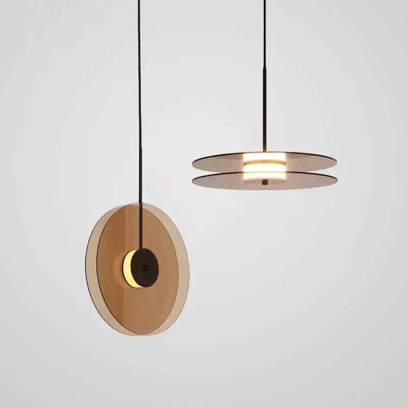 Modern amber smoke gray glass pendant lamp with translucent amber smoke discs and black metal frame for dining room decorbites