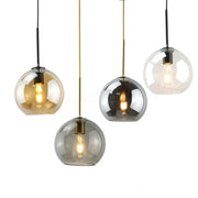 Set of four amber smoked gray and clear glass ball led pendant lights with brass and black rods for dining room decorbites pendant lights