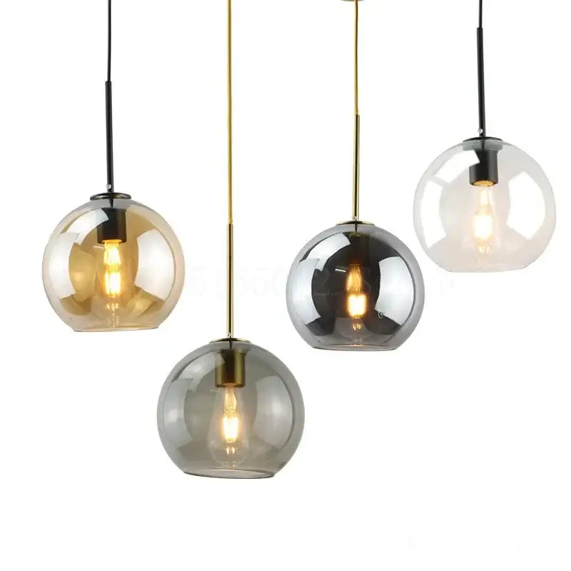 Set of four amber smoked gray and clear glass ball led pendant lights with brass and black rods for dining room decorbites pendant lights