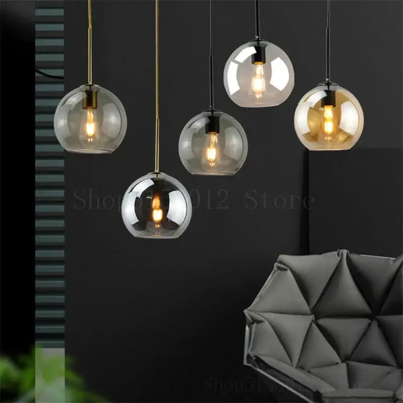 Modern amber smoked gray and clear glass ball led pendant lights with brass and black metal accents for dining room decorbites glass ball