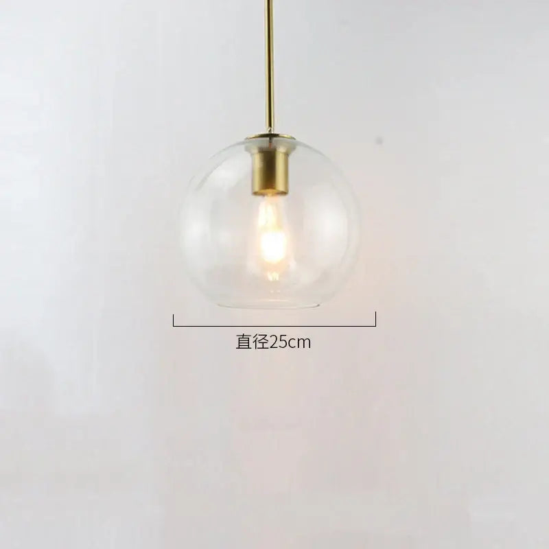 A clear glass ball led pendant light with brass finish and exposed bulb for modern dining room decorbites pendant lights