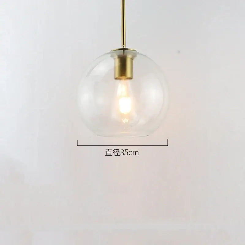 Modern amber smoked gray and clear glass ball led pendant lights with a clear globe and brass decorbites glass ball fixture